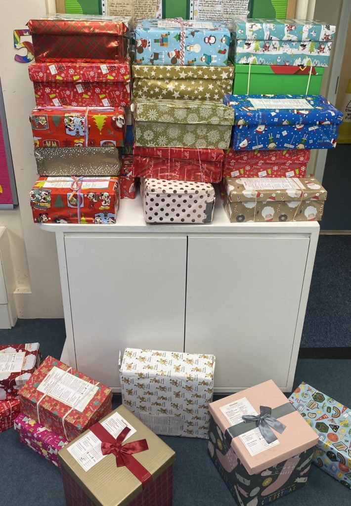 Shoeboxes decorated in Christmas wrapping paper